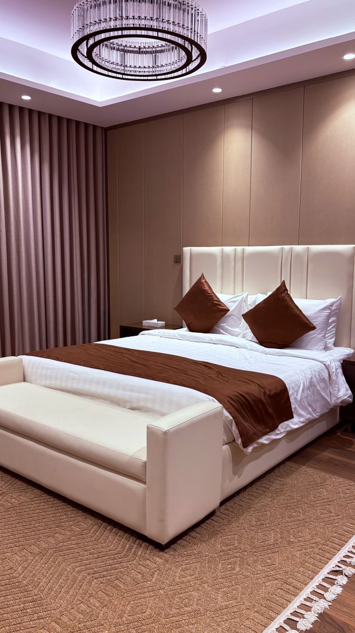 about-us-01 Sophisticated bedroom interior featuring elegant design and ambient lighting.